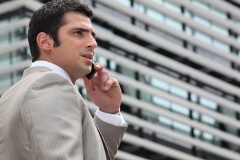Young man talking on phone outdoors