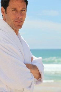 Man on the beach in bath robes