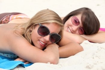 Two teenage girls sunbathing