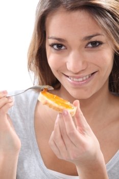 Woman eating toast with jam