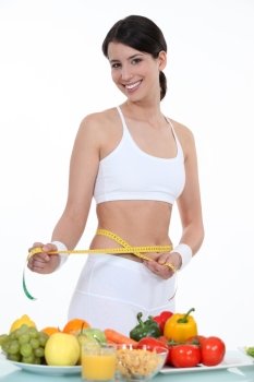 Sporty woman measuring waist