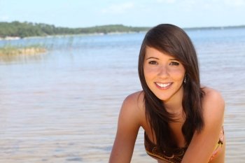 Teenage girl sat at the beach