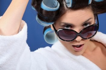 Woman wearing sunglasses and hair rollers