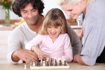 Father and daughter playing chess