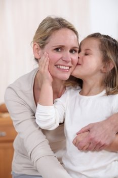 Daughter kissing mother
