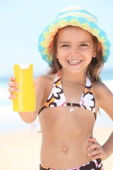 Little girl on the beach with cream