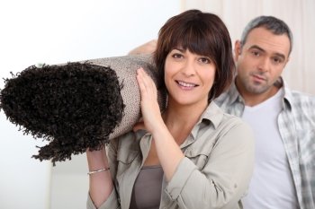 Couple carrying rug