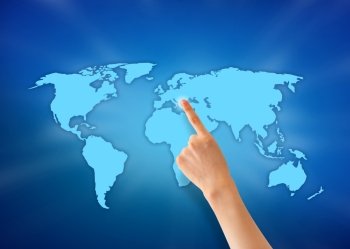 Hand pointing at a world map on blue background.