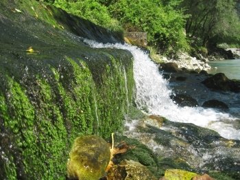 Low and wide waterfall. Abhazia travel