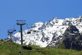 Empty cableway and caucasus mountains background