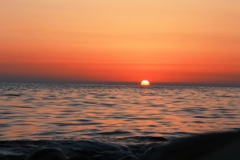 Summer sunset on the beach of the sea