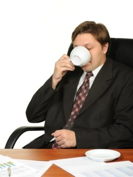 The businessman drinking coffee. It is isolated on a white background