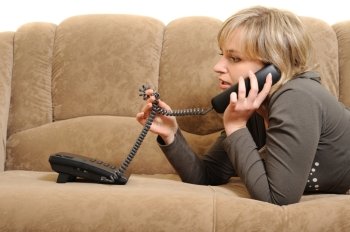 The woman speaking by phone on a sofa.House conditions