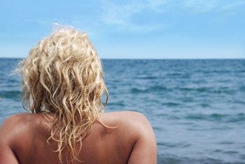 The effective blonde on a sea beach (a swarty sunburnt leather)