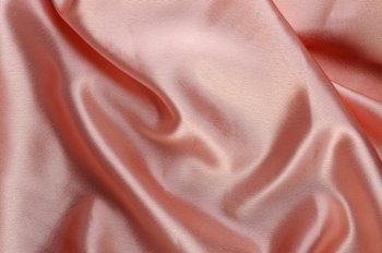 creamy satin background. A satiny fabric with beautiful light-shadow waves