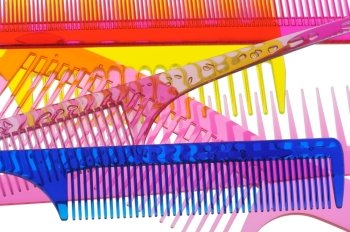 Set multi-coloured transparent combs. It is photographed on a gleam. It is isolated on a white background