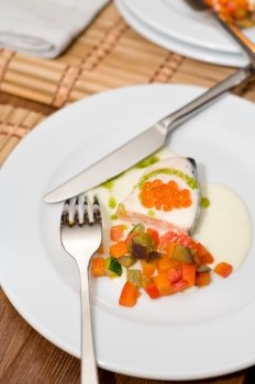 salmon under cream sauce with red caviar garnished with stewed vegetables