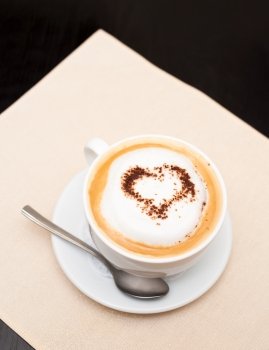 cappuccino coffee, chocolate heart on top, copy space