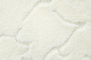 a woolen white carpet with a relief pattern