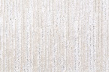 a woolen white and beige carpet, a closeup shot