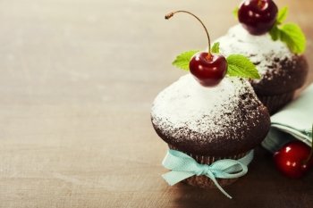 fresh chocolate muffins with cherry
