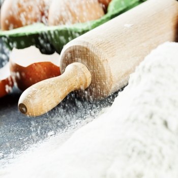 baking background with raw eggs, rolling pin and flour