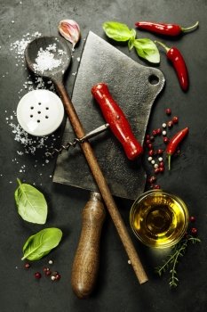 Vintage cutlery and fresh ingredients on dark background