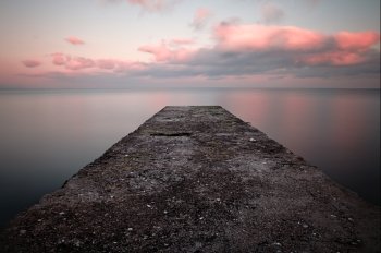 Calm sea sunset with a jetty