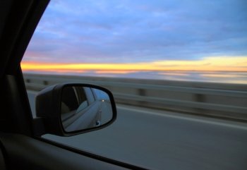 view in the rearview mirror on the car on highway
