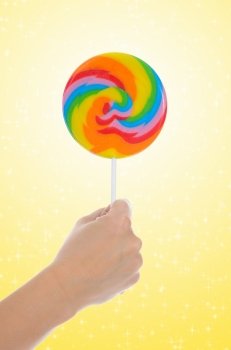 Large lollipop on stick on color background