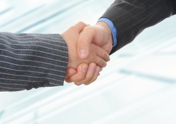 Handshake of business partners on the background of an office building