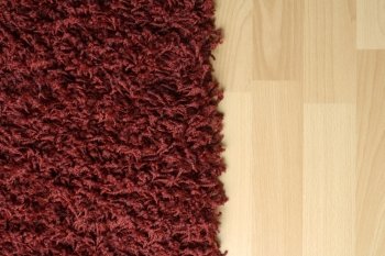 Red fluffy rug on laminate floor