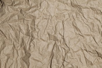 Old crumpled brown paper background texture.