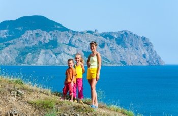 Summer rocky coastline and happy family for  walk (Crimea, Ukraine ).