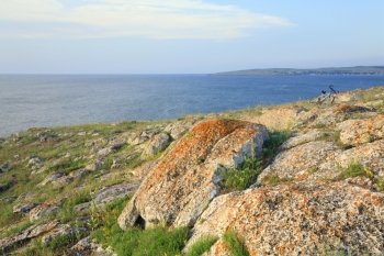 Summer sea and bike on stony coastline (Kazantip reserve, Crimea, Ukraine).