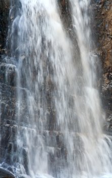 High mountain waterfall in dark wild Carpathian forest