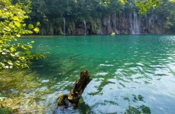 Beautiful summer waterfalls and green  limpid lake in Plitvice Lakes National Park (Croatia)