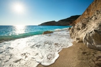 Beautiful summer coast Porto Katsiki beach on Ionian Sea (Lefkada, Greece) with sun in sky and wave
