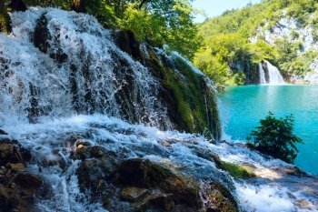Small waterfall (closeup) and azure  limpid lake in Plitvice Lakes National Park (Croatia)
