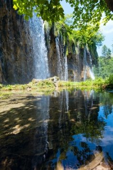 Reflections of waterfall on small pure transparent lake (Plitvice Lakes National Park, Croatia)