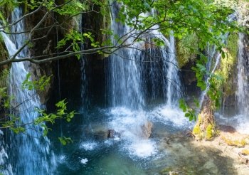 Summer view of beautiful waterfall and grotto (Plitvice Lakes National Park, Croatia)