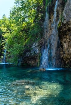 Beautiful summer waterfalls and limpid lake view in Plitvice Lakes National Park (Croatia)