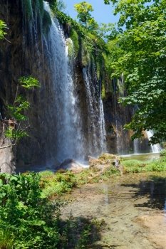 Summer view of large waterfall  in Plitvice Lakes National Park (Croatia)