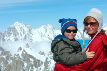Family on observation area and Mont Blanc mountain massif behind (view from Aiguille du Midi Mount,  France )