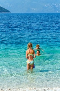 Family bathing in the sea. Summer vacation (Greece, Kefalonia, Beach Antisamos).