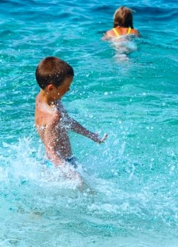 Children bathing in the sea. Summer vacation (Greece, Kefalonia, Beach Antisamos).