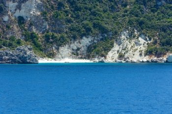 Small sandy beach and summer coast view from train ferry (Kefalonia, Greece)