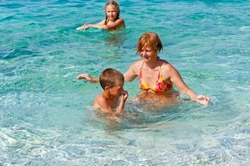 Family bathing in the sea. Summer vacation (Greece, Kefalonia, Beach Antisamos).