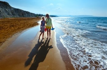 Mother with daughter on Xi Beach. Morning view (Greece, Kefalonia).