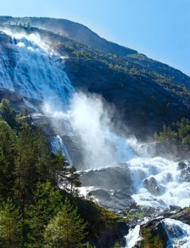Summer mountain  Langfossen waterfall on slope (Etne, Norway).